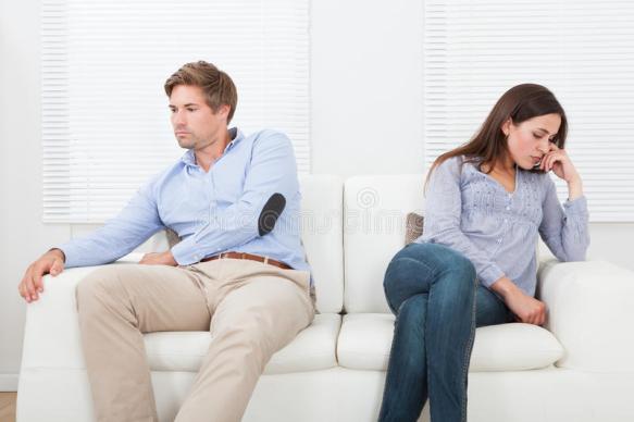 couple-ignoring-each-other-sofa-full-length-sitting-home-46359800